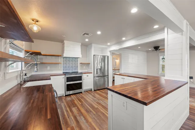 a bathroom with a granite countertop double vanity sink and a mirror