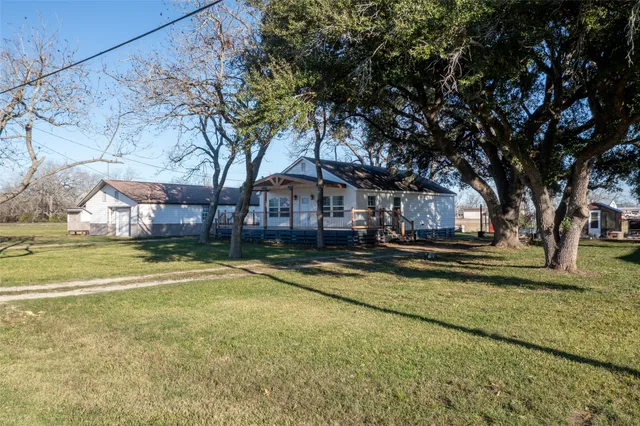 a front view of a house with a yard table and chairs