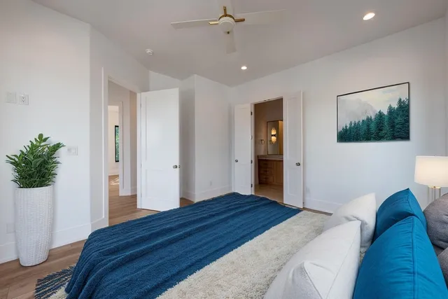 a bedroom with a bed and a painting on the wall