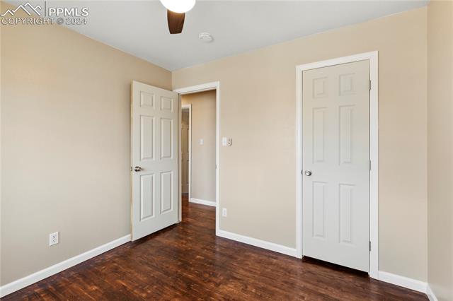 14 Duncan Road Pueblo, CO 81001 - Photo 12 of 26 Unfurnished bedroom featuring ceiling fan and dark hardwood flooring. bedroom #3