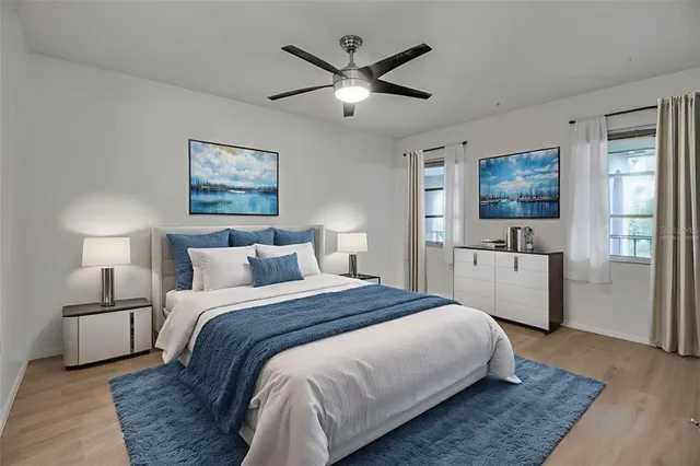 a bedroom with a large bed and a chandelier