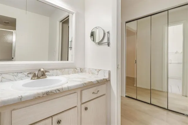 a bathroom with a granite countertop sink and a mirror