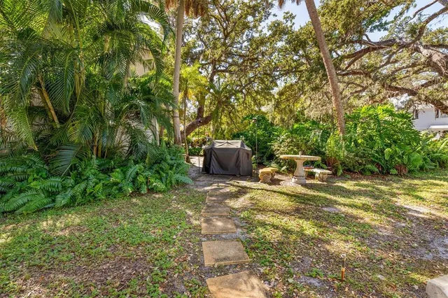 a backyard of a house with table and chairs