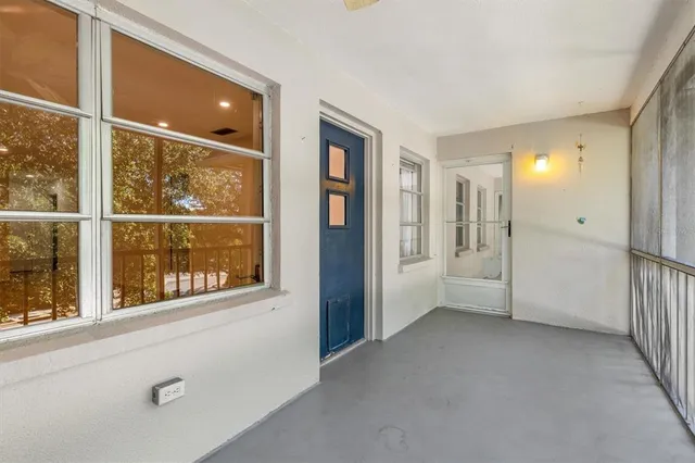 an empty room with a window and doors