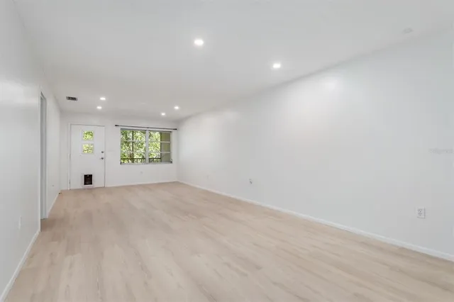 a view of an empty room and a window