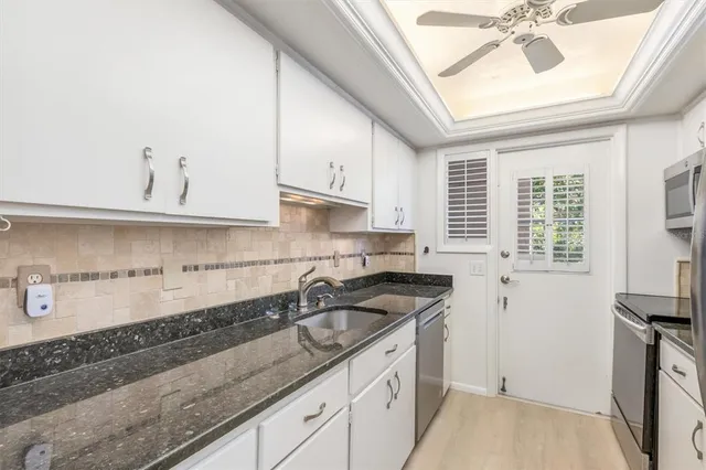 a kitchen with a sink cabinets and window