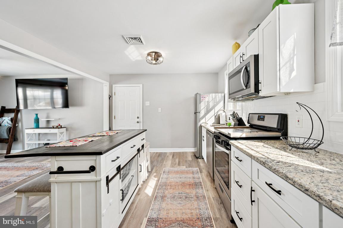 8 Lancia Place Lindenwold, NJ 08021 - Photo 11 of 24 a kitchen with stainless steel appliances granite countertop a sink stove and cabinets