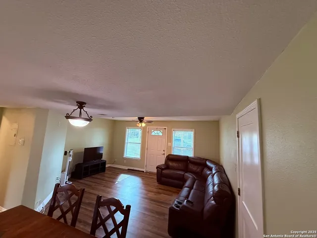 a living room with furniture and a mirror