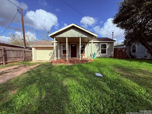 a view of a house with a yard and sitting area