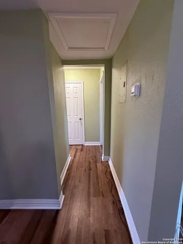 a view of a hallway with wooden floor