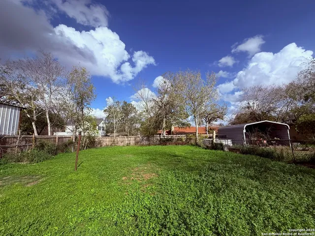 a view of a garden with a house