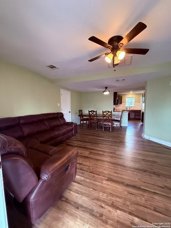 a living room with lots of furniture and wooden floor