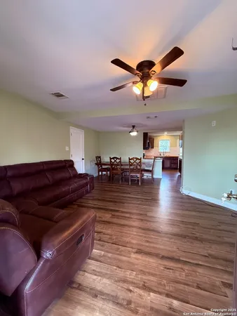 a living room with lots of furniture and a chandelier