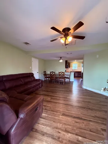 a living room with lots of furniture and a chandelier