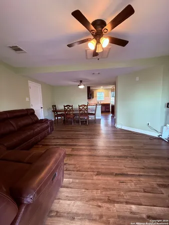 a living room with lots of furniture and a chandelier