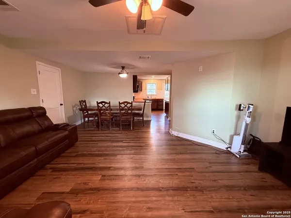a living room with furniture wooden floor and chandelier