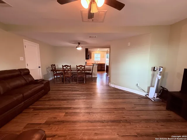a living room with furniture wooden floor and chandelier