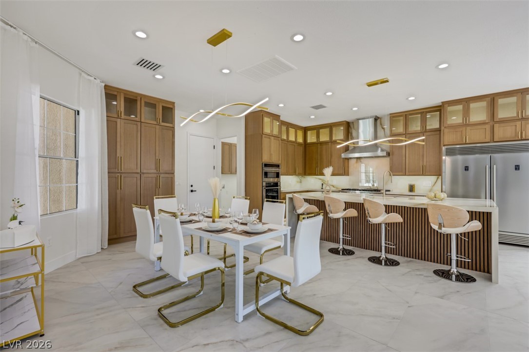 5015 Rivedro Street Las Vegas, NV 89135 - Photo 15 of 91 A grand open-concept space featuring a gourmet kitchen and a versatile dining area.