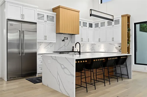 a large kitchen with stainless steel appliances kitchen island granite countertop a large counter top stainless steel appliances and cabinets