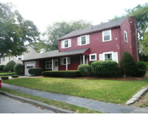 7 Surrey Road Salem, MA 01970 - Photo 2 of 15 a view of a brick house with a yard and large trees