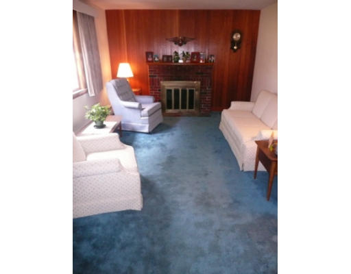 7 Surrey Road Salem, MA 01970 - Photo 7 of 15 a living room with furniture and a fireplace