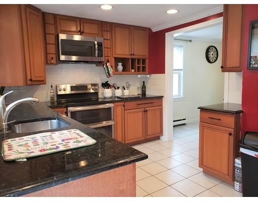 20 Mellen Street Hopedale, MA 01747 - Photo 14 of 22 a kitchen with a sink a stove a microwave and wooden cabinets