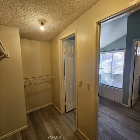 en empty room with window and wooden floor