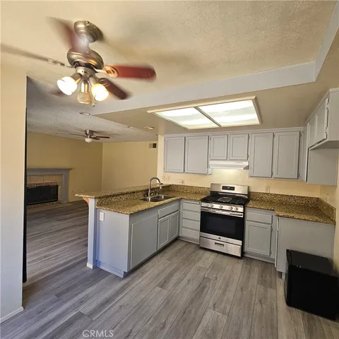 a view of a room with a window and wooden floor