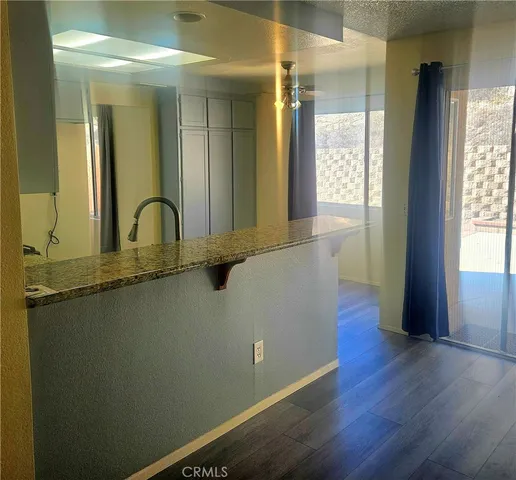 a kitchen with granite countertop a sink and cabinets