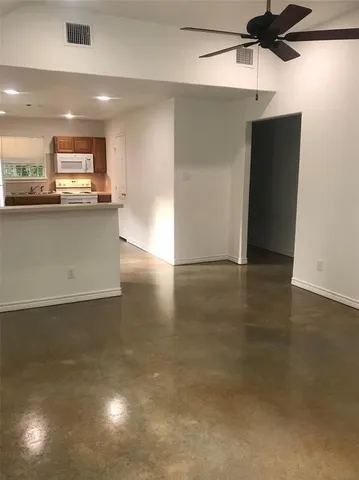 a view of kitchen with refrigerator and a stove top oven