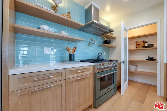 a kitchen with stainless steel appliances granite countertop a stove and a refrigerator