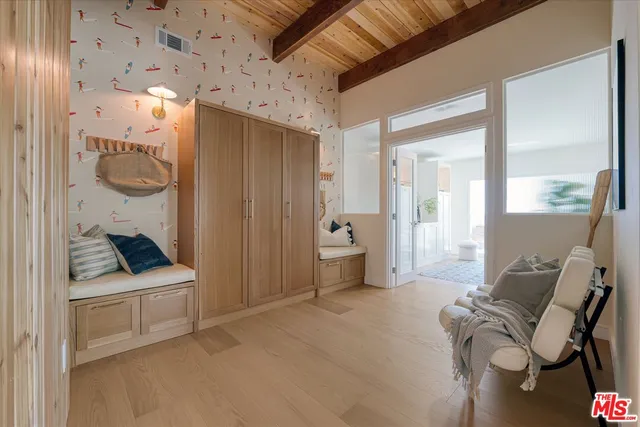 a bedroom with furniture and a painting on the wall