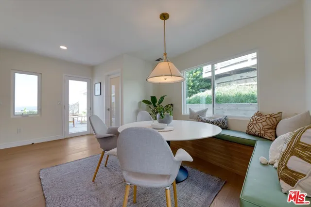 a view of a dining room with furniture window and wooden floor