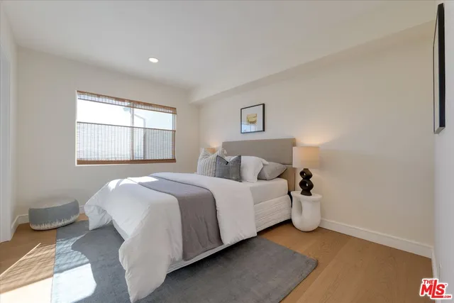 a spacious bathroom with a toilet a sink and mirror