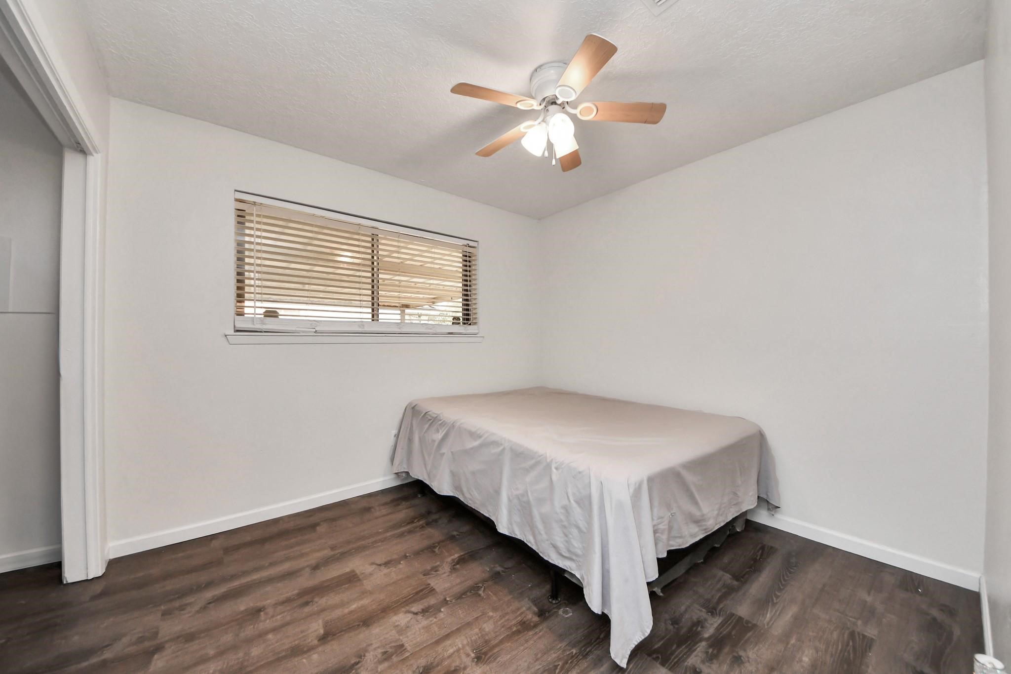 1415 Parry-Sound Pasadena, TX 77504 - Photo 31 of 34 a bed sitting in a bedroom next to a window