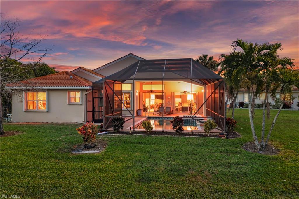 1411 Princess Sabal Point Naples, FL 34119 - Photo 21 of 31 Rear view of house featuring a sunroom, a yard, glass enclosure, and an outdoor pool