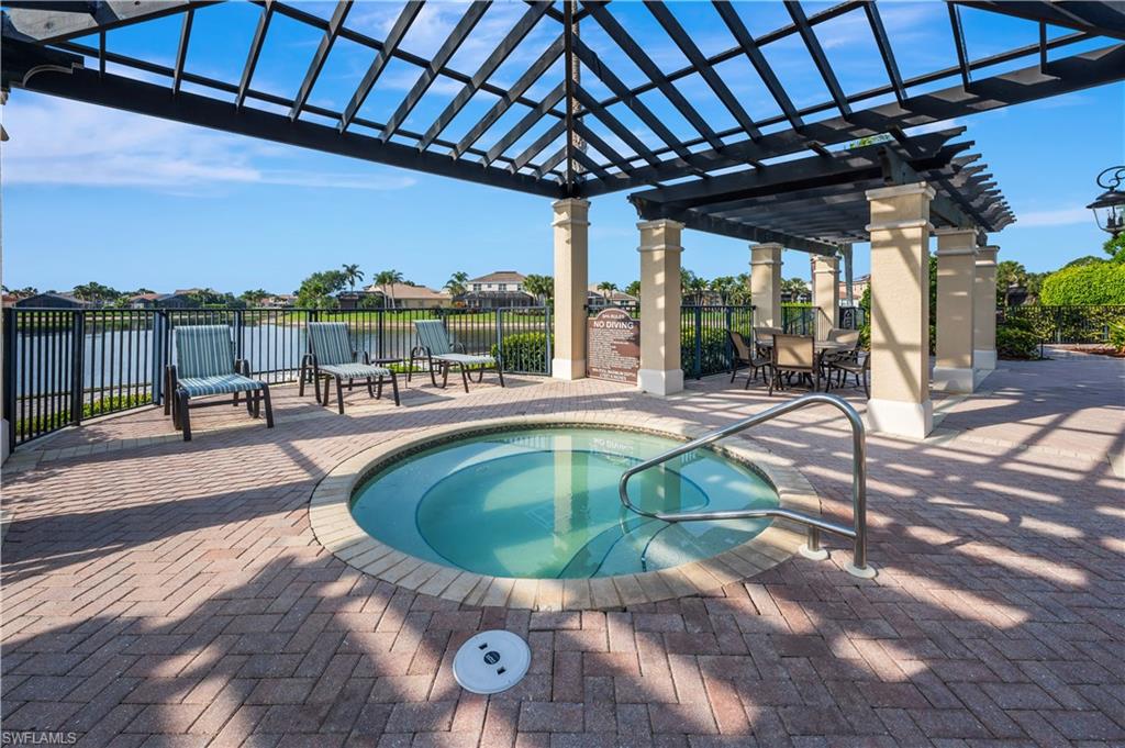 1411 Princess Sabal Point Naples, FL 34119 - Photo 26 of 31 View of swimming pool with a pergola, patio surround, a swimming pool, outdoor dining area, and a water view