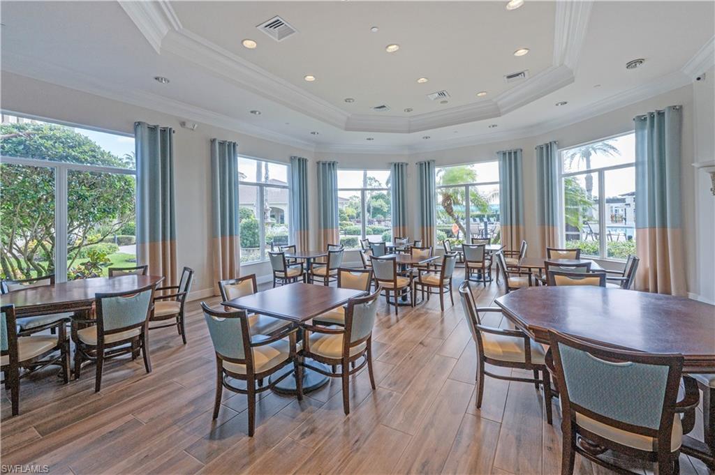 1411 Princess Sabal Point Naples, FL 34119 - Photo 28 of 31 Dining space with light wood-style floors, crown molding, and a tray ceiling