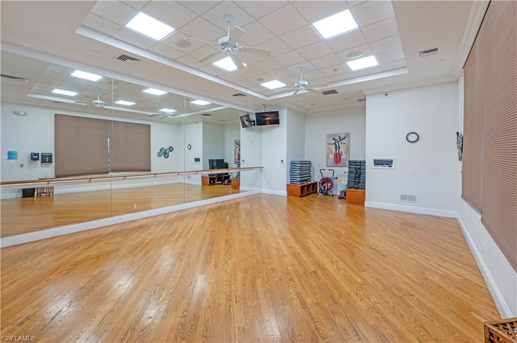 1411 Princess Sabal Point Naples, FL 34119 - Photo 29 of 31 Exercise area with a drop ceiling, a tray ceiling, crown molding, and ceiling fan