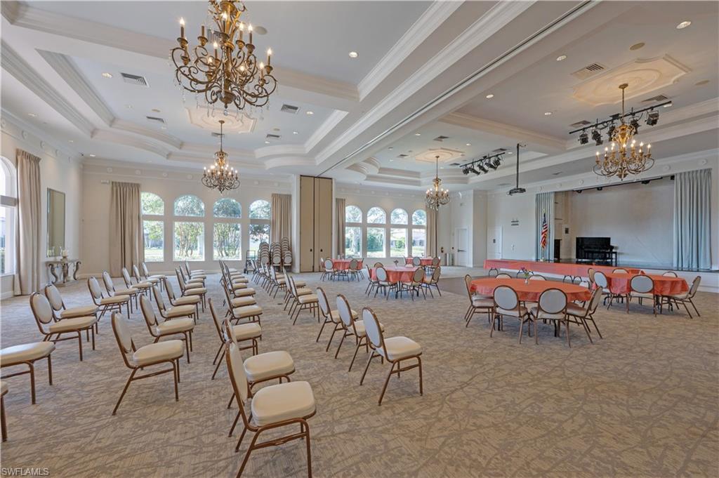 1411 Princess Sabal Point Naples, FL 34119 - Photo 31 of 31 Dining room with suspended lighting, light colored carpet, crown molding, and a tray ceiling