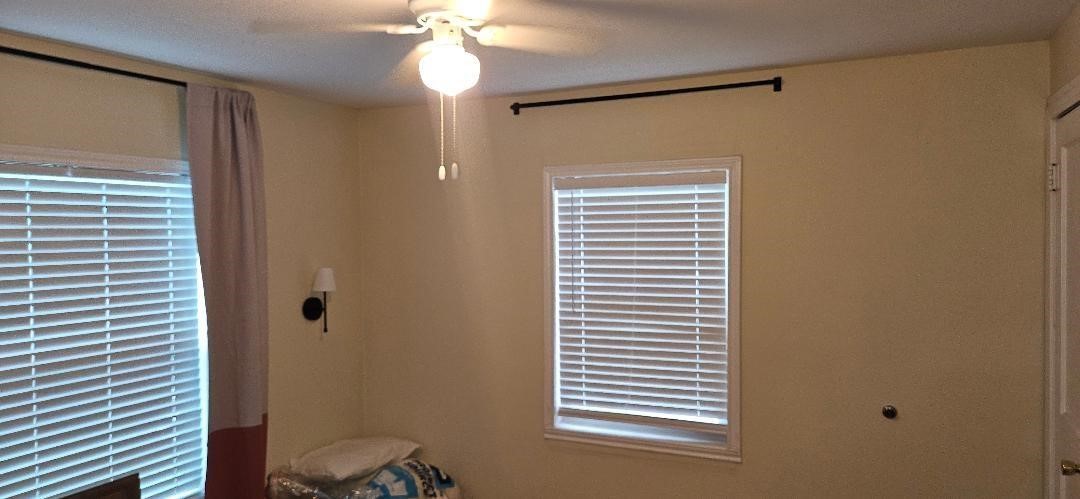 932 Walling Street Houston, TX 77009 - Photo 19 of 23 a bathroom with a window and a shower curtain