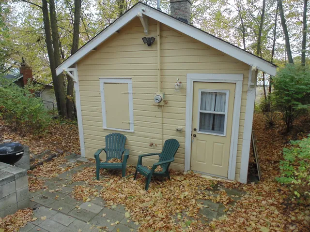a backyard of a house with table and chairs