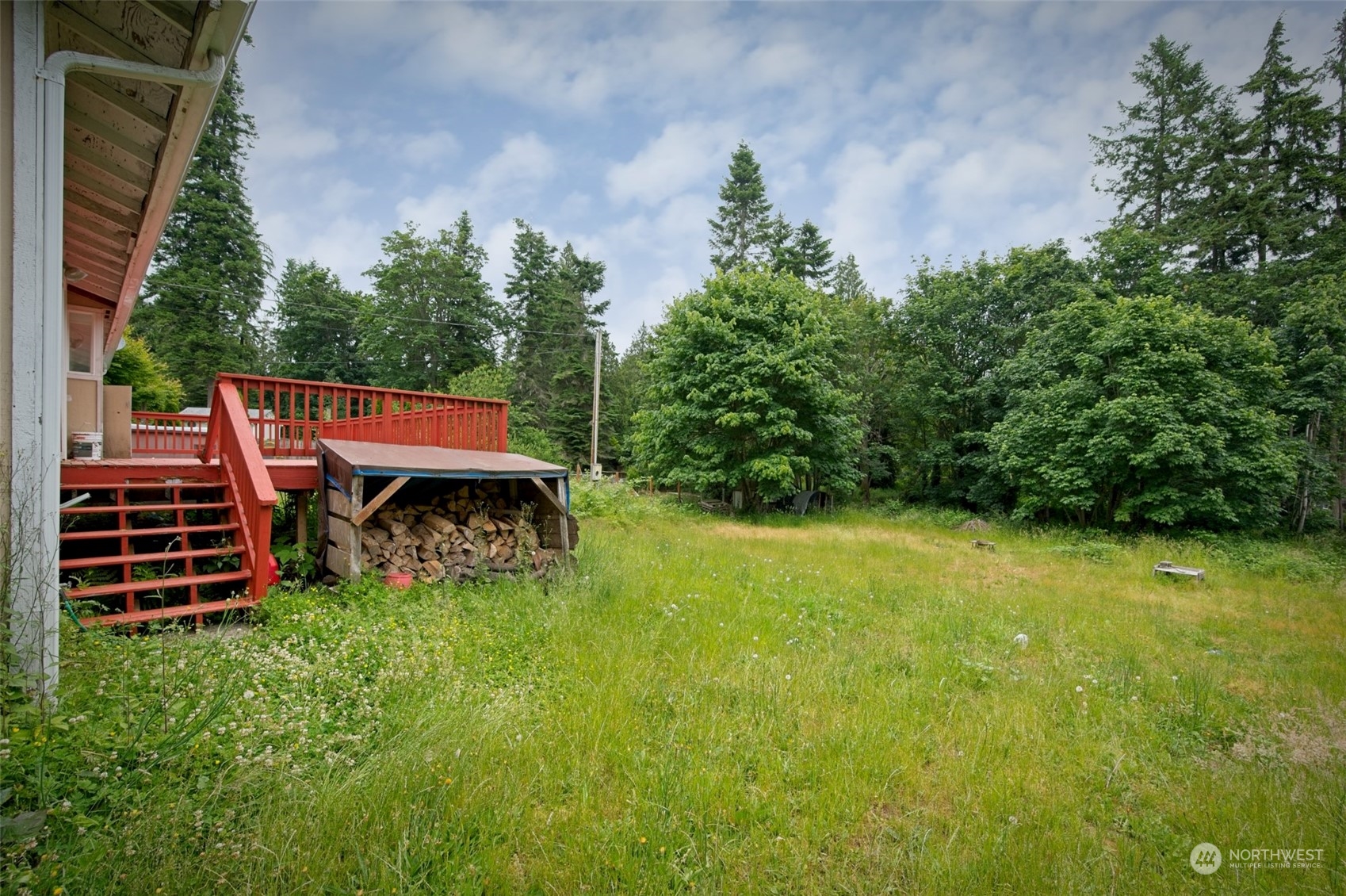 8121 Shoemaker Road Marysville, WA 98271 - Photo 3 of 20 a view of a patio with table and chairs a barbeque with potted plants and a large tree
