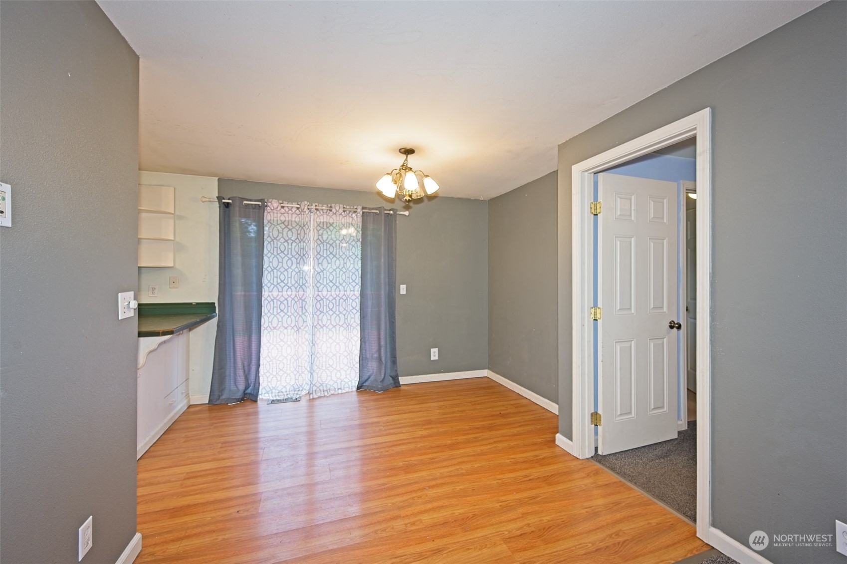 8121 Shoemaker Road Marysville, WA 98271 - Photo 10 of 20 a view of a hallway with wooden floor and a chandelier