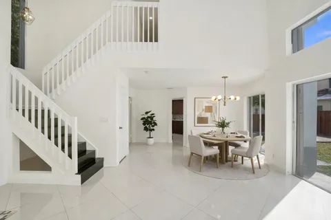 a dining room with furniture and window