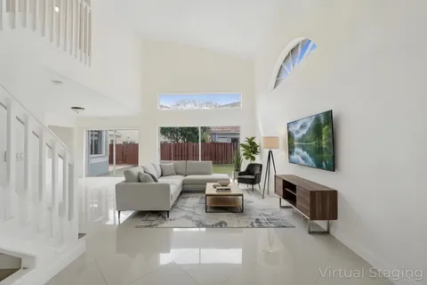 a living room with furniture and a potted plant
