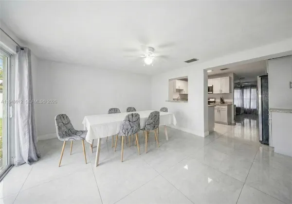 a view of a dining room with furniture and a chandelier