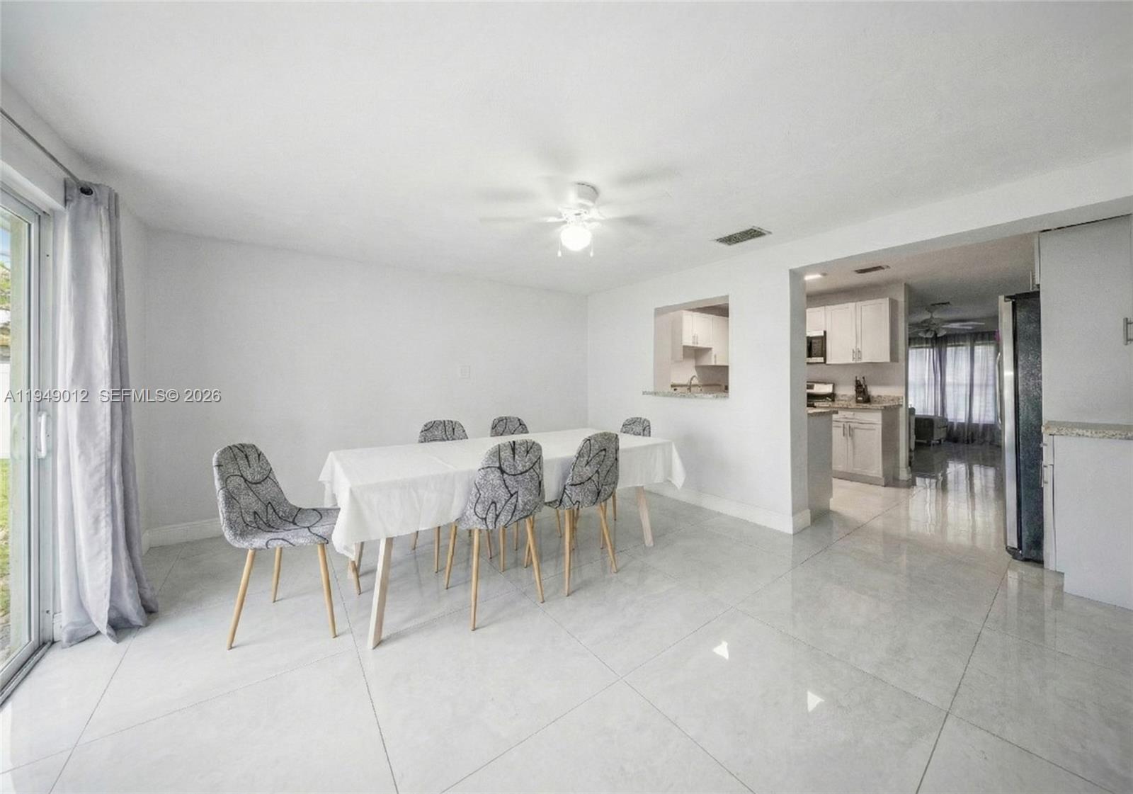 6971 Southwest 24th Street Miramar, FL 33023 - Photo 11 of 22 a dining room with furniture and a chandelier