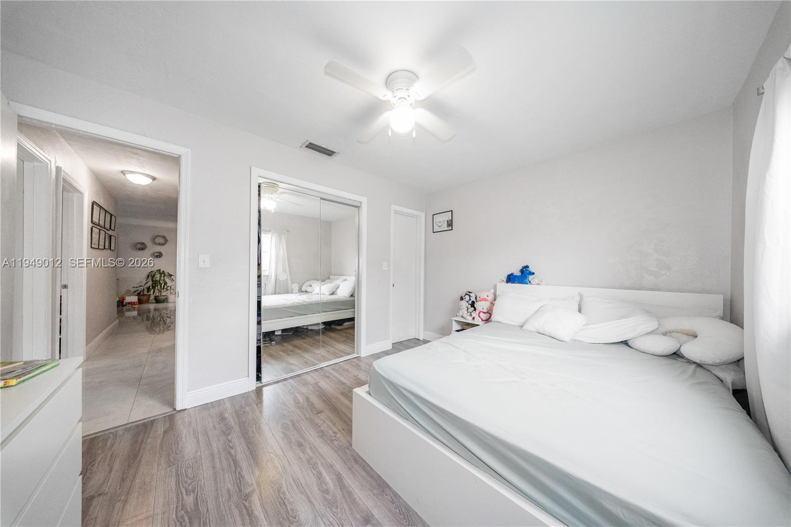 6971 Southwest 24th Street Miramar, FL 33023 - Photo 13 of 22 a bedroom with a bed and a large mirror