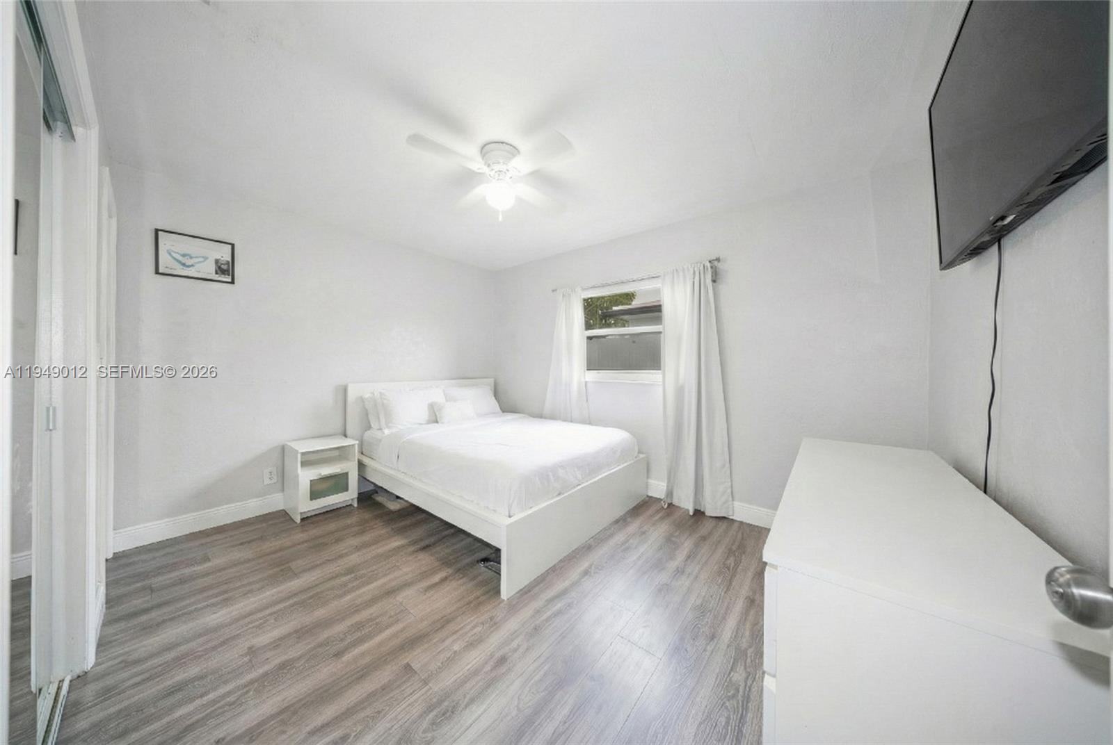 6971 Southwest 24th Street Miramar, FL 33023 - Photo 15 of 22 a bedroom with a bed and a flat screen tv